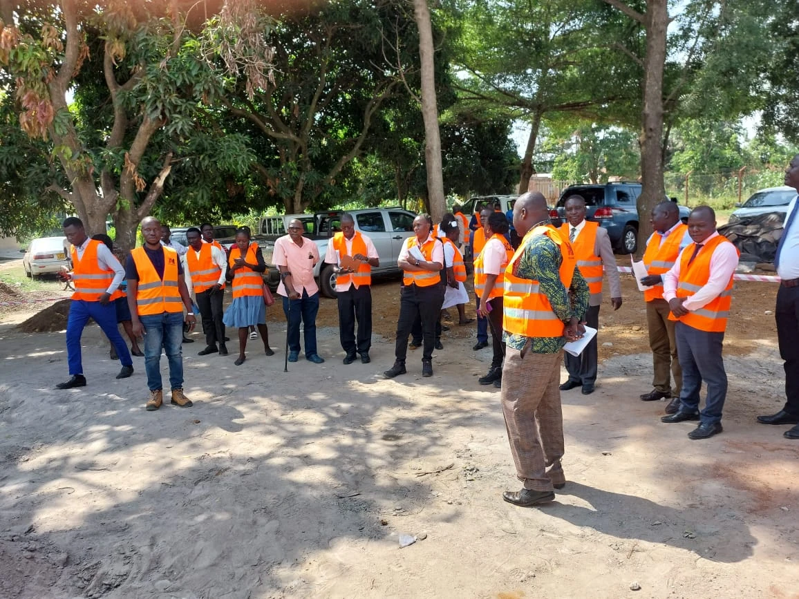 Akol Holdings team gathered on site wearing orange safety vests